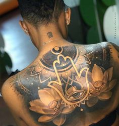 the back of a woman's body with tattoos on her upper and lower half