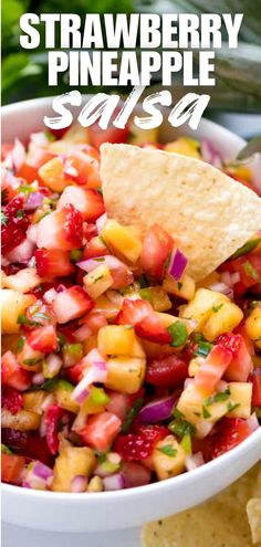 strawberry pineapple salsa in a white bowl with tortilla chips on the side