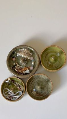 four bowls with different designs on them sitting next to each other