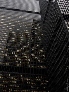 a black and white photo of skyscrapers in the city