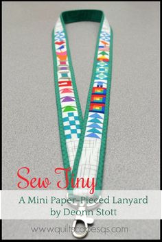 a green and white lanyard with the words sew tiny on it's side