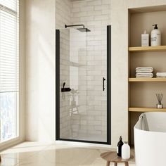 a bath room with a stand up shower next to a tub and shelves filled with towels