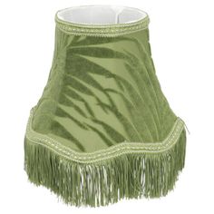 a green lamp shade with fringes on it