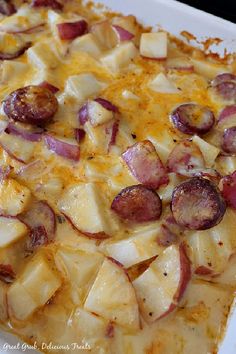 a casserole dish with potatoes, ham and cheese on it is ready to be eaten