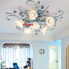 a living room filled with furniture and a chandelier hanging from the middle of the ceiling