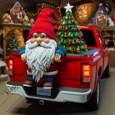 a red pick up truck with a christmas tree in the bed and santa clause on it