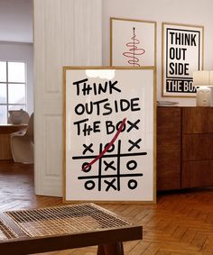 there is a sign that says think outside the box next to a table with a clock on it