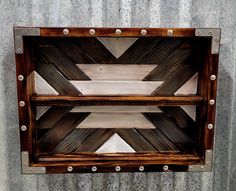 a wooden shelf with metal rivets on it