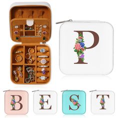 an open jewelry case with flowers and letters on the front, inside and outside it