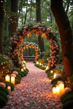 a pathway with candles and flowers on the sides, surrounded by greenery in the middle