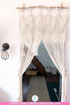 a white curtain hanging on the side of a wall