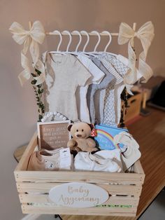 a wooden crate filled with baby items on top of a table