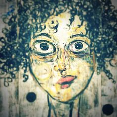 an artistic drawing of a woman's face with curly hair and eyes wide open