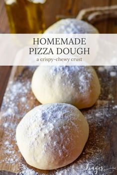 three homemade pizza doughs sitting on top of a cutting board with powdered sugar