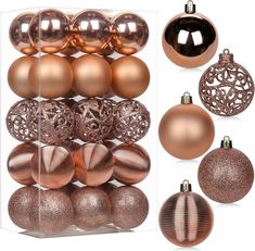 christmas ornaments are displayed in an acrylic display case, including gold and silver baubles