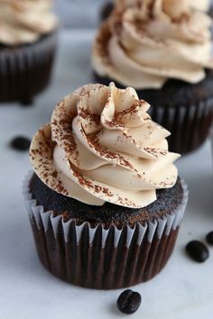 chocolate cupcakes with white frosting and sprinkles