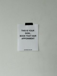 this is your sign, book that hair appointment on a white paper pinned to the wall