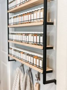 the spice rack is hanging on the wall next to towels and other items in front of it