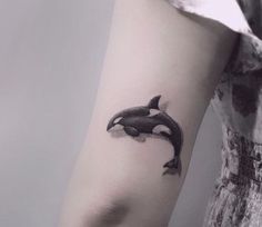 an orca whale tattoo on the arm