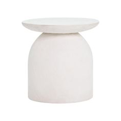 a white vase sitting on top of a table