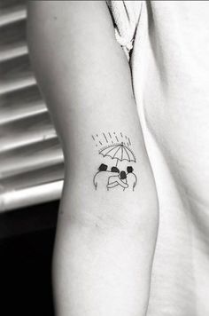 a woman's arm with an umbrella tattoo on the left side of her body