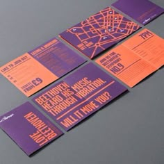 purple and orange wedding stationery with city map in the middle, on grey background