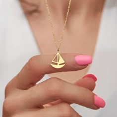 This exquisite necklace captures the adventurous spirit of the open sea with its elegant sailboat design. Crafted from stunning 14k gold, this necklace is a true treasure that will never go out of style. The 14k gold construction adds a touch of luxury and refinement to the necklace, ensuring that it will be a cherished piece in your jewelry collection for years to come. The bright and shining gold catches the light beautifully, creating a radiant glow that will complement any outfit. This sailb Tiny Sailboat, Sailboat Necklace, Ocean Sailing, Metal Jewelry Making, Sailboat Design, Pearl Necklace Designs, Repurposed Jewelry, Zodiac Pendant, Jewelry Dainty