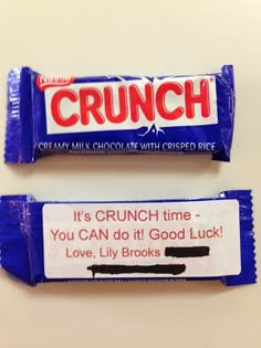 two candy bars sitting next to each other on top of a white table with the words crunch written on them