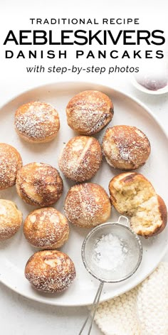 a white plate topped with pastries covered in powdered sugar