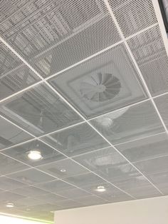 the ceiling in an office building is covered with mesh