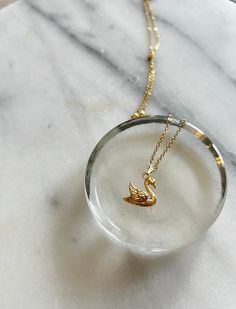 My Handmade Swan Pendant Necklace is elegant and romantic! Crafted on an anti-tarnish gold-plated chain that sparkles with every movement, this necklace exudes subtle glamour. The centerpiece is a stunning gold-plated swan pendant, adding a touch of sophistication to any outfit. Whether you're dressing up for a special occasion or adding a bit of glamour to your everyday look, this necklace is sure to make a statement. Handmade with care, it offers both style and quality. Swan Pendant, Grandmillenial Style, Gold Swan, Swan Necklace, Silver Swan, Romantic Jewelry, Necklace Elegant, Romantic Jewellery, Bird Charm