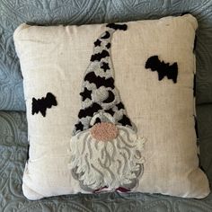 a decorative pillow with a gnome face on it