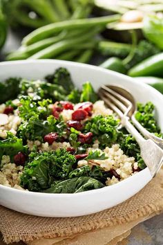 a white bowl filled with rice, broccoli and cranberries