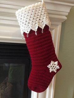 a crocheted christmas stocking hanging from a fireplace