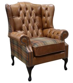 a brown leather chair sitting on top of a floor next to a pile of furniture