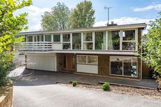 this is an image of a house with large windows on the front and side of it