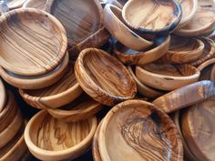 many wooden bowls are stacked on top of each other