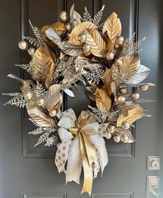 a wreath with gold leaves and pearls hanging on the front door to give it a festive touch