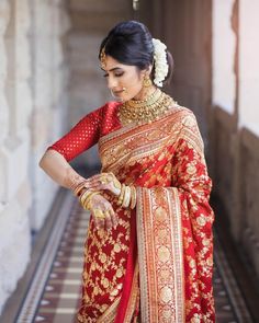 a woman in a red and gold sari