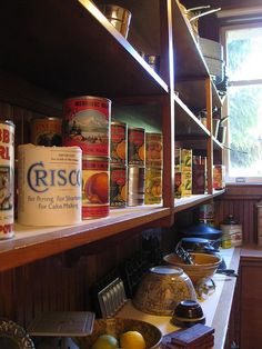 the shelves in this kitchen are full of food