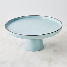 a blue cake plate on a marble surface