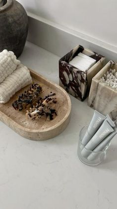 a bathroom counter with soaps, toothbrushes and other items