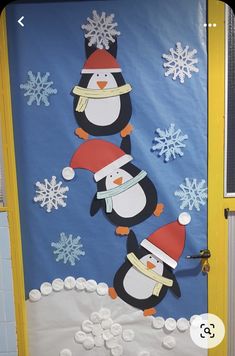 a door decorated with penguins and snowflakes