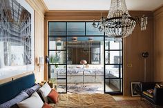 a bedroom with a chandelier hanging from the ceiling