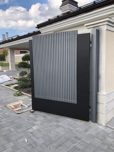 a black and silver gate on the side of a building