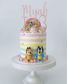 a birthday cake decorated with cartoon characters and frosting