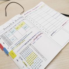 an open planner sitting on top of a wooden table