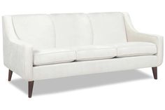 a white couch sitting on top of a wooden floor