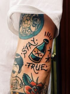 a man with tattoos on his arm and leg, showing the words stay true in different languages