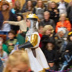 a man dressed as a knight in front of a crowd